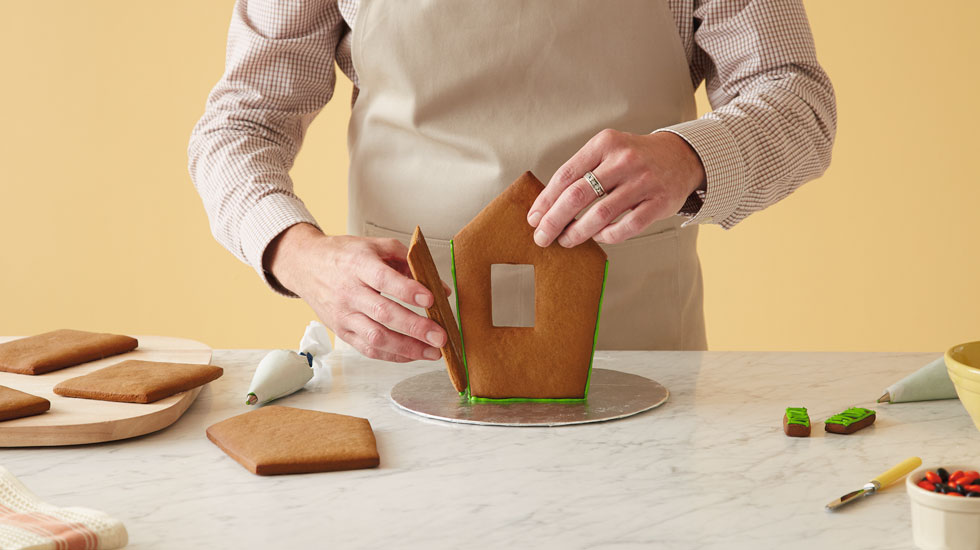 How to make a Halloween gingerbread house: press panels together on base