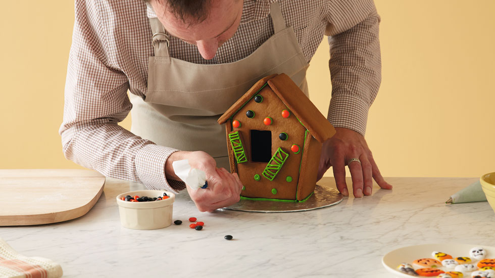 How to make a Halloween gingerbread house: add candy decorations