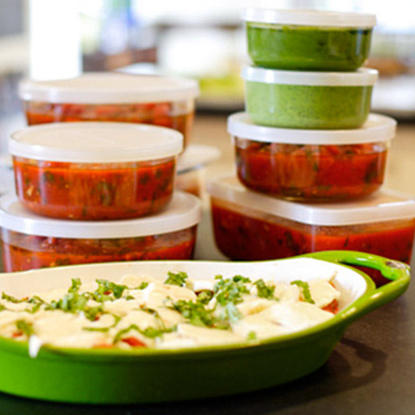 A dish of food with several leftover containers.