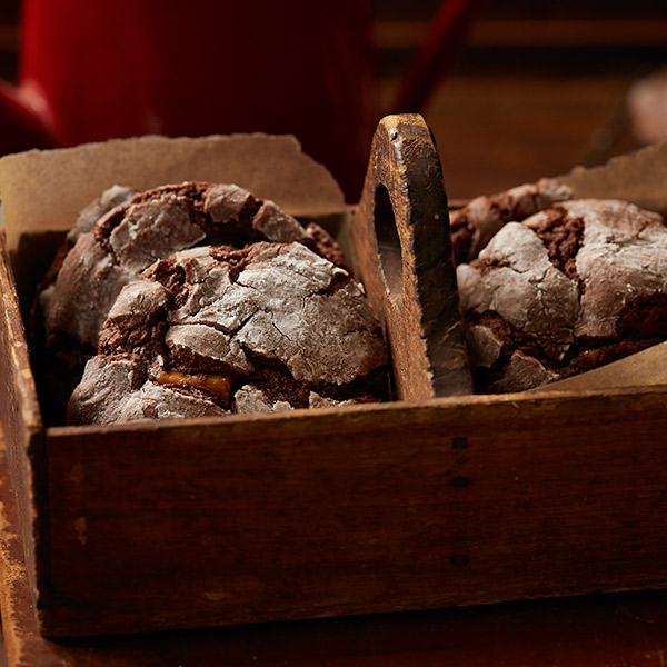 Chocolate crinkle cookies with crispy ridges and a dusting of powdered sugar.