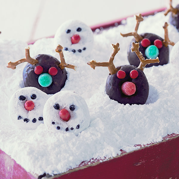 Christmas donuts decorated as reindeer for chocolate donuts and snowmen for powdered sugar donuts.