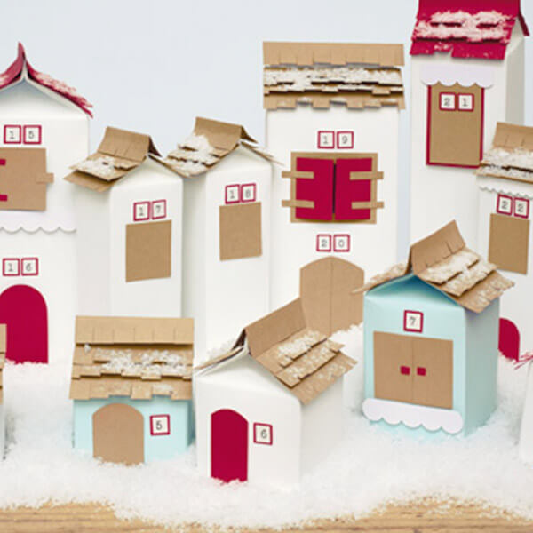 Christmas village DIY advent calendar with dates on houses in the village.