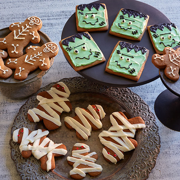 Halloween gingerbread cookies decorated and shaped like skeletons, mummies and Frankenstein.