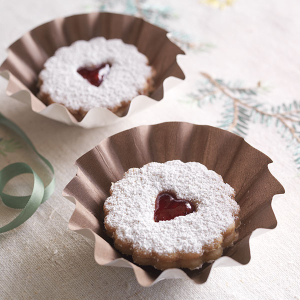 Raspberry linzer cookies with jam filling, heart-shaped cutout and a dusting of powdered sugar.