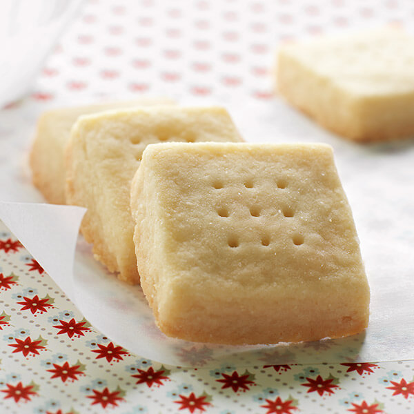 Crispy shortbread cookies with an array of holes in a square pattern.