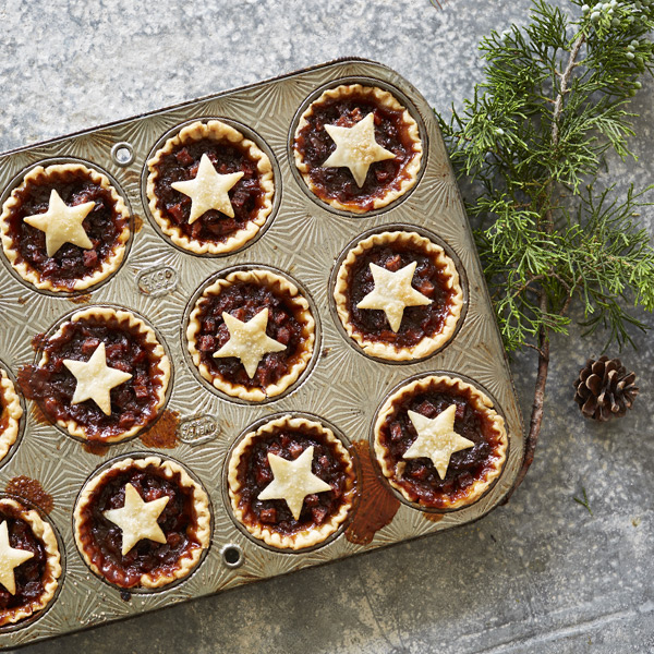 Mincemeat tarts in a cupcake pan with star-shaped crust decals on top.