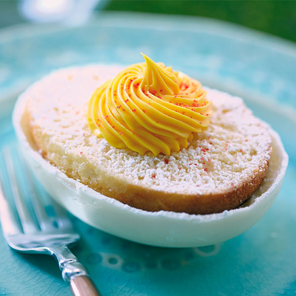 Mini easter cake with white cake as the white and yellow frosting as the yolk.