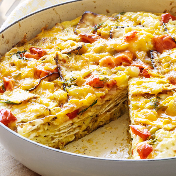 Skillet layered with matzo brei including bell peppers and onions.