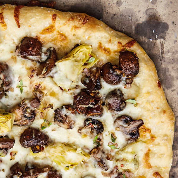 Mushroom-artichoke grilled pizza with artichoke hearts, mushrooms and mozzarella and Parmesan cheeses.