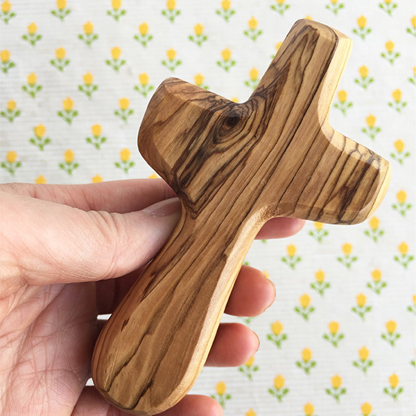 An organic-looking cross made of wood.
