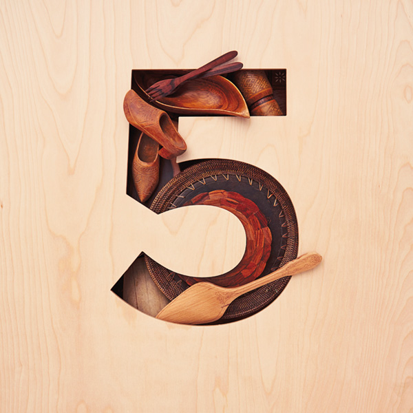 5-anniv-ideas The number 5 (for 5th anniversary) cut from a piece of light-colored wood, filled with objects carved from wood (for the traditional 5th anniversary gift)