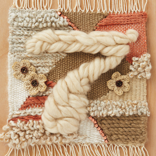 7-anniv-ideas The number seven (for 7th anniversary) braided in chunky, off-white woold roving (wool is one of the traditional 7th anniversary gifts) on a background weaving that includes peach, tan and off-white yard and crocheted flowers