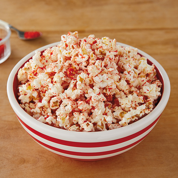 Spiced popcorn with a reddish tint from spicy corn snacks.