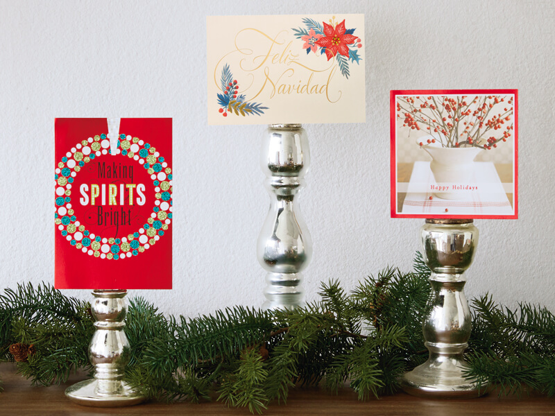 Christmas card displays using candlesticks.