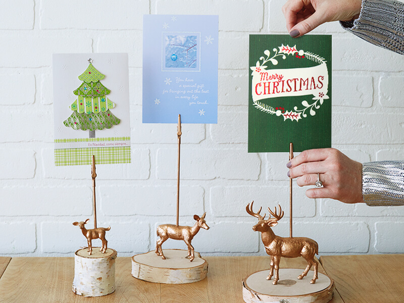 Securing Christmas cards into the homemade deer Christmas card holder.