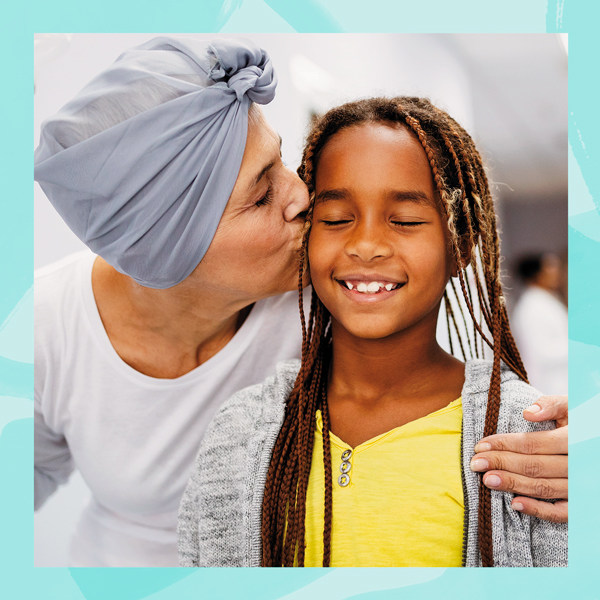 Mother with cancer kissing daughter