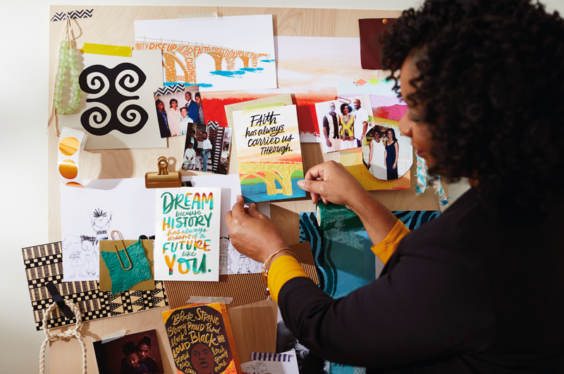 Editorial Director Dierdra (“Dee”) Zollar with cards on art board