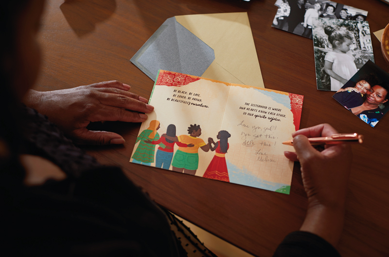 Melvina Young writing in a card