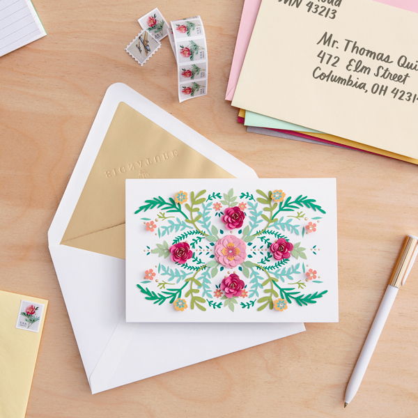 card and envelope on desk with pen