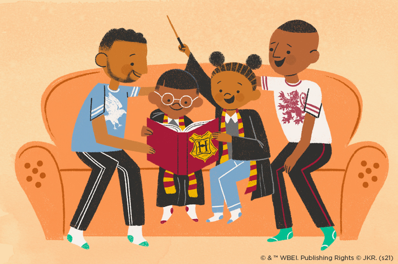 family reading harry potter book on couch with costumes