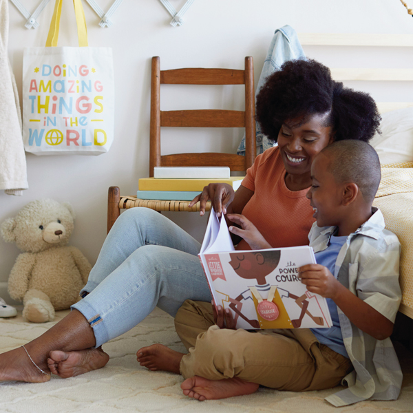 Mother and son reading book about courage