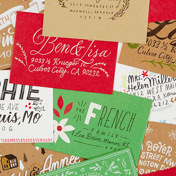 PIle of decorated and hand-lettered envelopes in various colors.