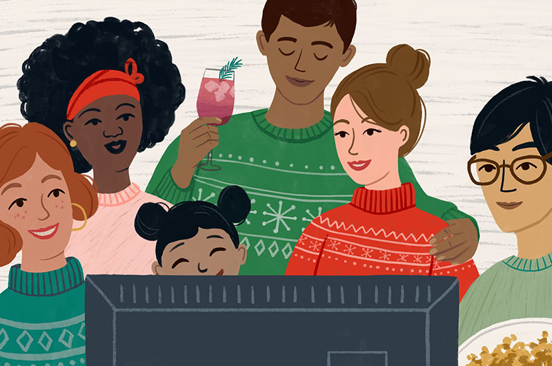 Group of people in holiday sweaters watching Christmas movies