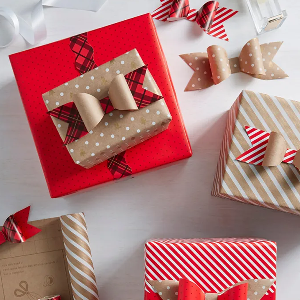 Red and Kraft brown gifts topped with DIY wrapping paper bows.