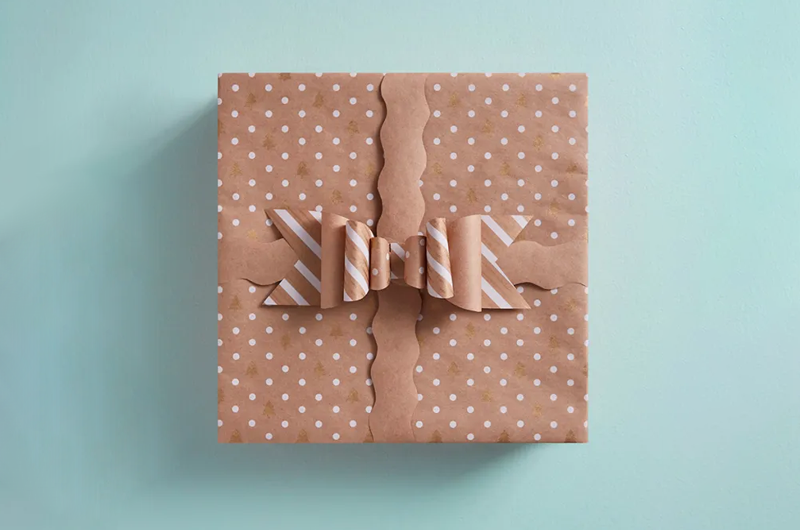Gift with polka dot wrapping paper and matching DIY wrapping paper bow.