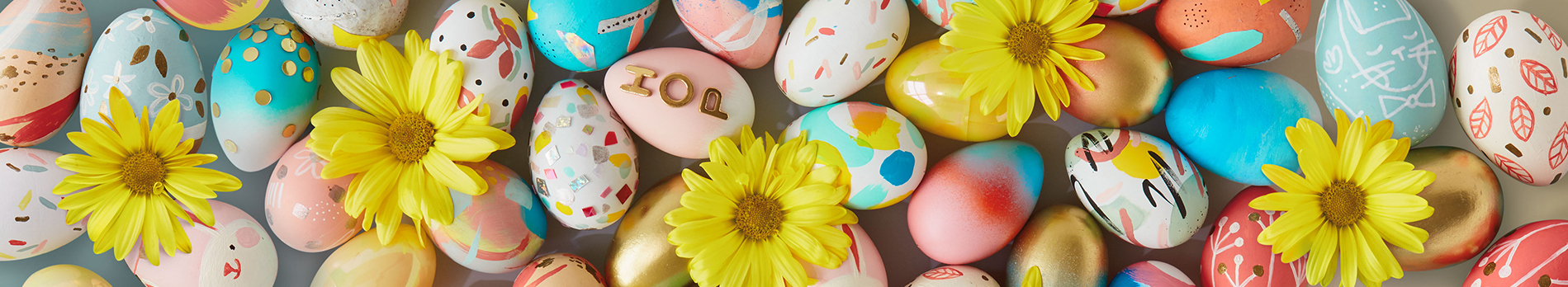 Easter background with colored eggs and yellow daisies