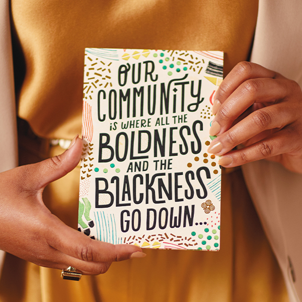 Hands holding an Uplifted and Empowered card that reads,