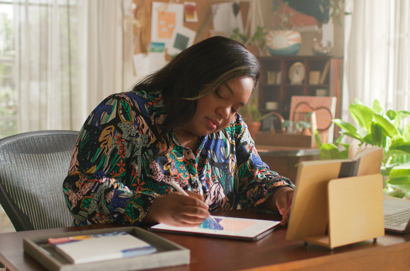 Morgan Harper Nichols at a desk, creating on her iPad.