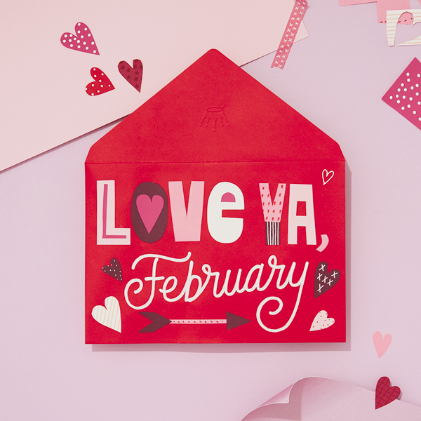 A red card envelope with cut-out letters that read,