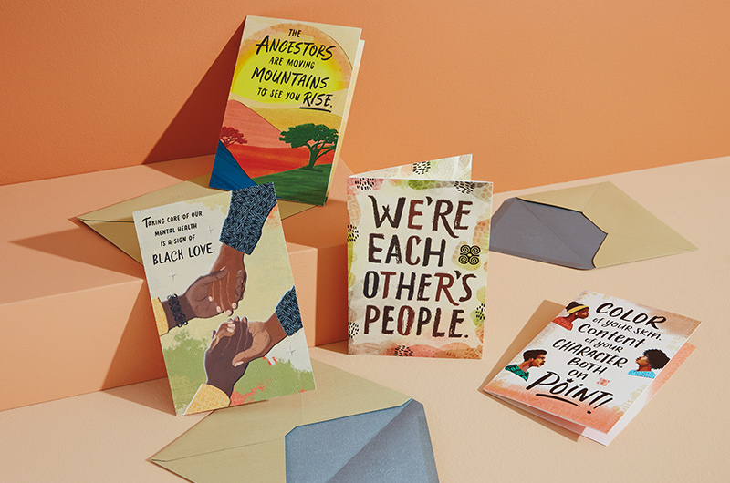A collection of four Uplifted and Empowered cards on an orange backdrop.
