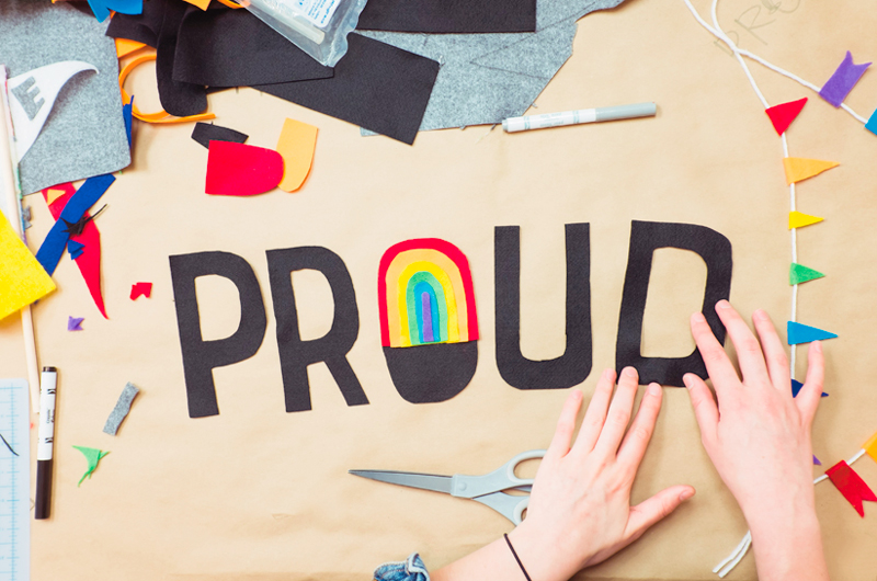 Hands placing cut felt letters that spell out