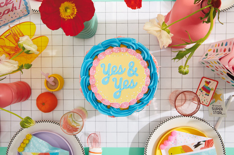 A cake with a free printable cake topper on top that reads,