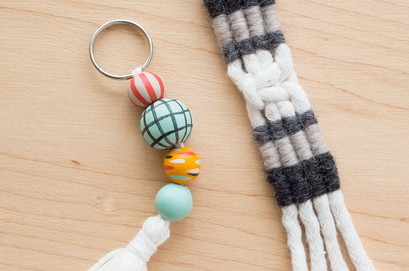 A beaded macramé keychain with a short tassel and a striped clove hitch macramé keychain.