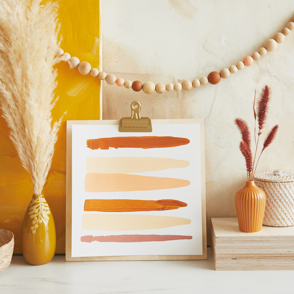 A tableau featuring DIY fall decor pieces in autumnal shades of brown, orange and beige.