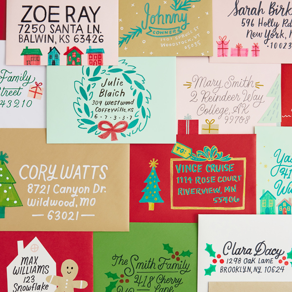 A collage of envelopes that have been hand lettered and decorated with holiday icons such as trees, gingerbread men and wreaths.