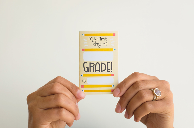A woman's hands hold up an assembled back-to-school zine.
