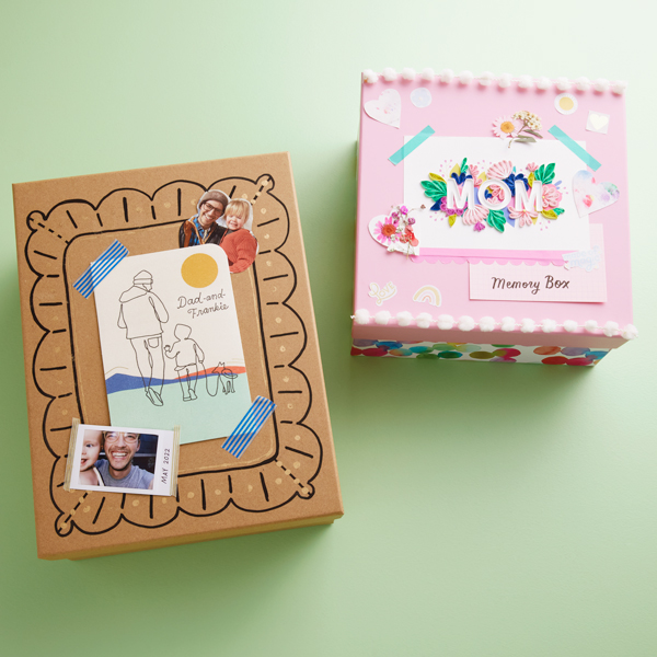 Decorated Father's Day and Mother's Day memory boxes sit on a light green surface.