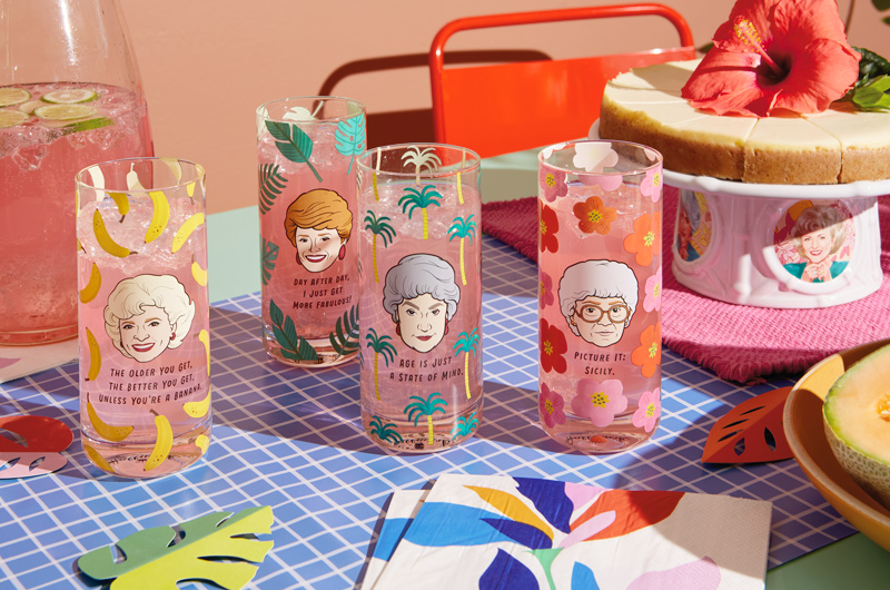 A set of four drinking glasses, each featuring an illustration of a different main character from TV's