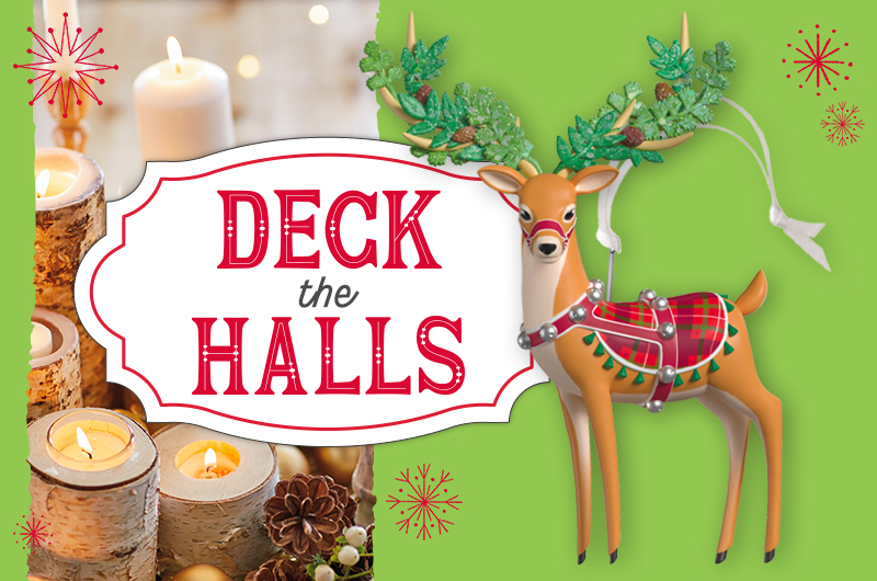 A Keepsake Ornament portraying a graceful reindeer decked out in a red and green plaid blanket, a red harness with silver jingle bells, and evergreen boughs woven in its antlers.