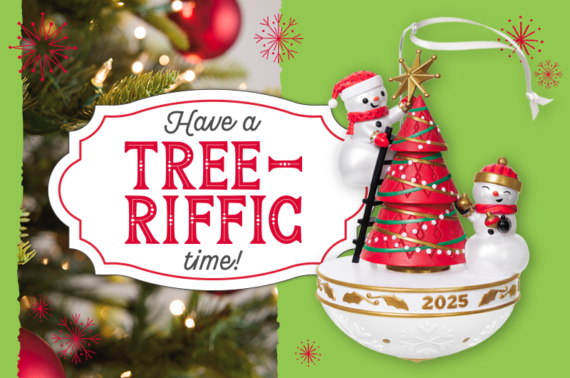 A 2025 Keepsake Ornament featuring two snowmen decorating a red Christmas tree strung with green and gold tinsel.