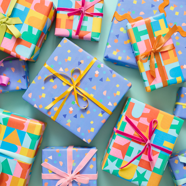 A collection of brightly wrapped gifts, each tied with a simple bow.
