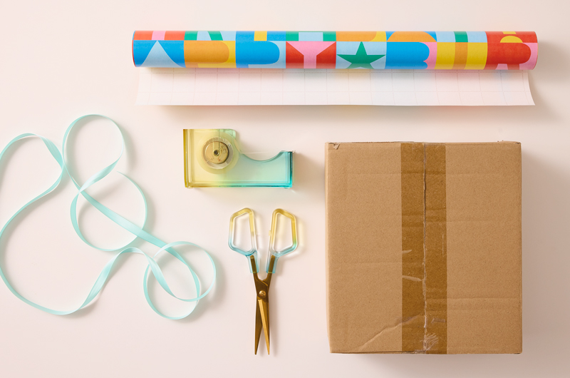 Materials needed to wrap a gift include gift wrapping paper, tape, scissors and ribbon, if desired.