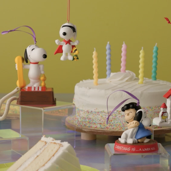 Peanuts ornaments and cake on yellow background