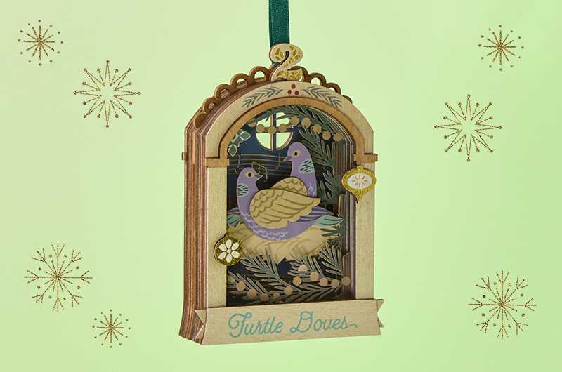 A wood and papercraft Keepsake Ornament from