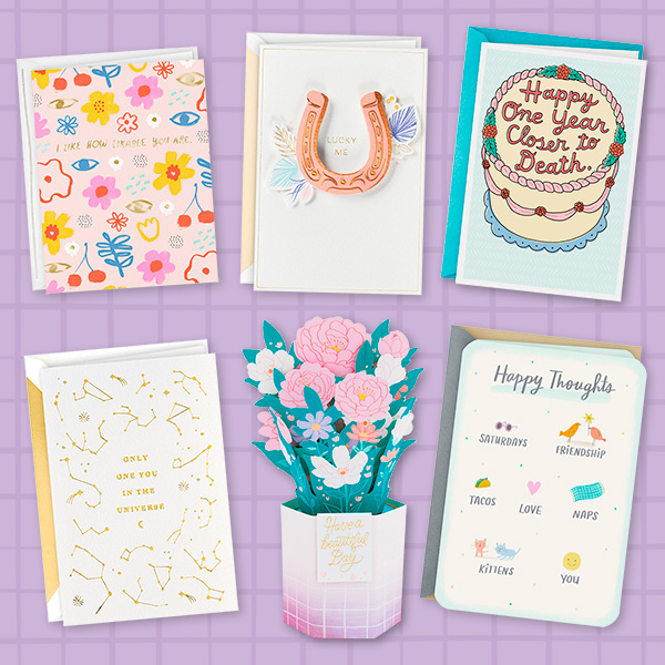 A collection of cards on a light purple grid background.