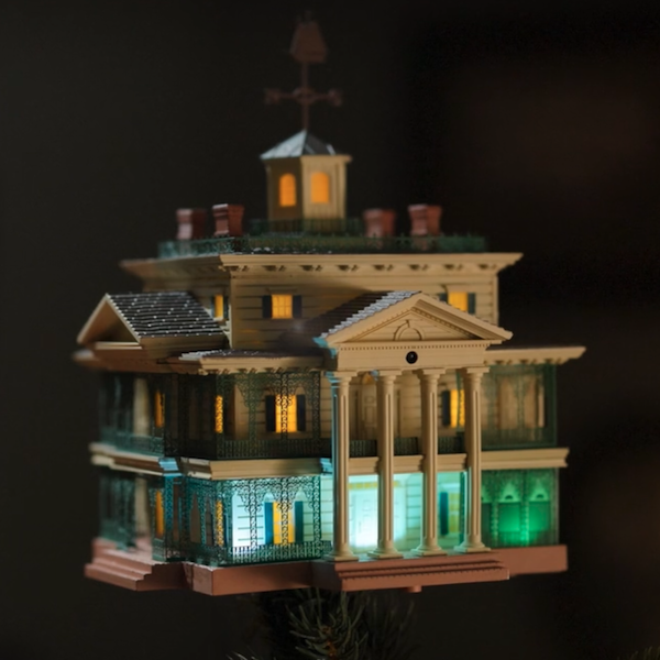 An interactive Christmas tree topper featuring light and sound in the form of the Disneyland Haunted Manor House.